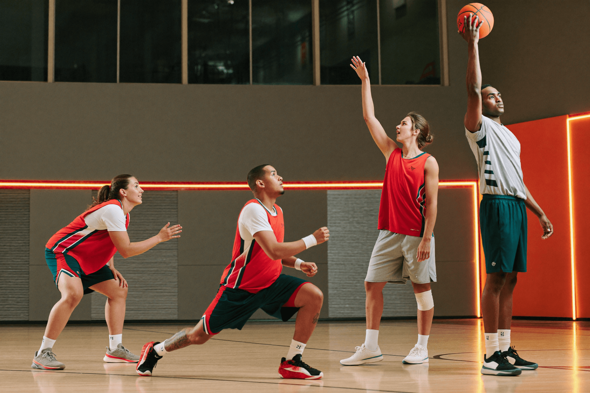 A small group of young players training together on an indoor court